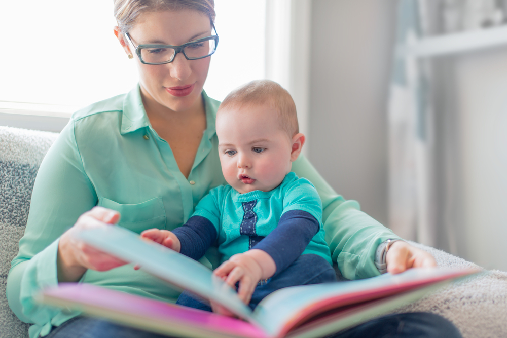 Cute baby reading with his mother Cute baby reading with his mother
